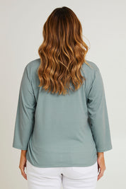 Model Laura wearing size 14 of The Bamboo Blend Printed 3/4 Slv Tee in colour Aquaspot (Green), from the back