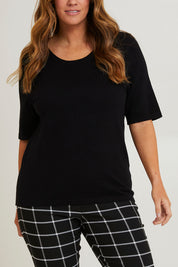 Model Laura wearing size L of The All Season Crew Neck Knit Tee in colour Black (Black), from the front, cropped image