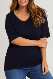 Model Laura wearing size L of The All Season Crew Neck Knit Tee in colour Clasicnavy (Blue), from the front, cropped image