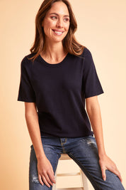 Model Madeline wearing size S of The All Season Crew Neck Knit Tee in colour Clasicnavy (Blue), from the front, showing the whole outfit