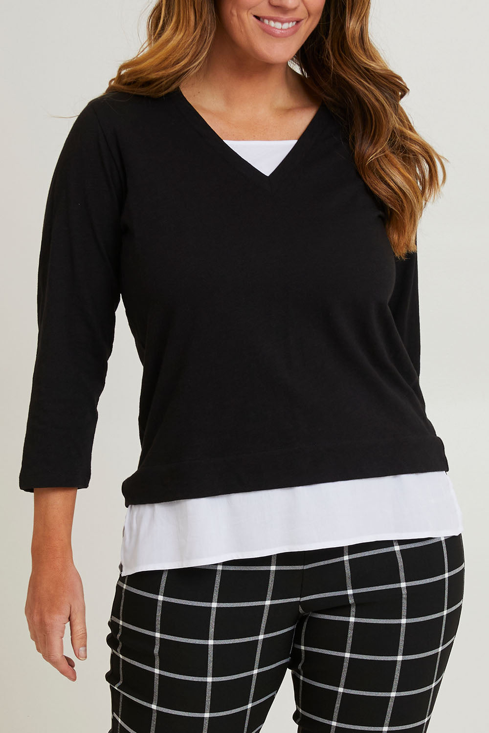 Model Laura wearing size 14 of The Keepers Layered Tee in colour Black (Black), from the front, cropped image