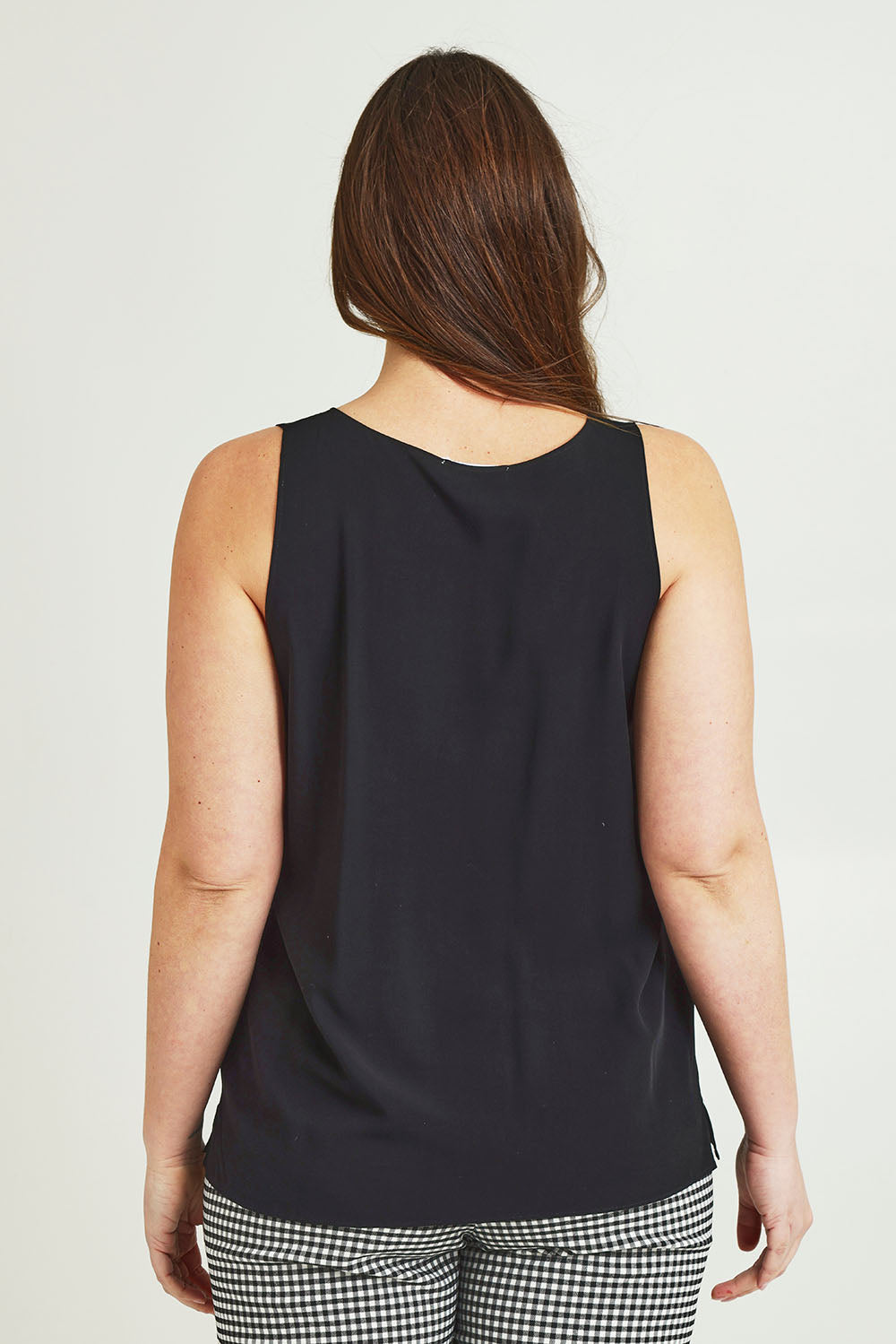 Model Jane wearing size 14 of The Keepers Essential Woven Tank in colour Black (Black), from the back