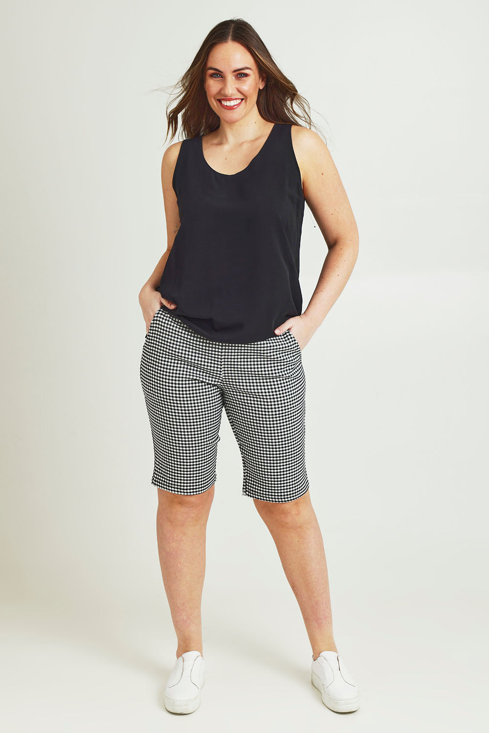 Model Jane wearing size 14 of The Keepers Essential Woven Tank in colour Black (Black), from the front, showing the whole outfit