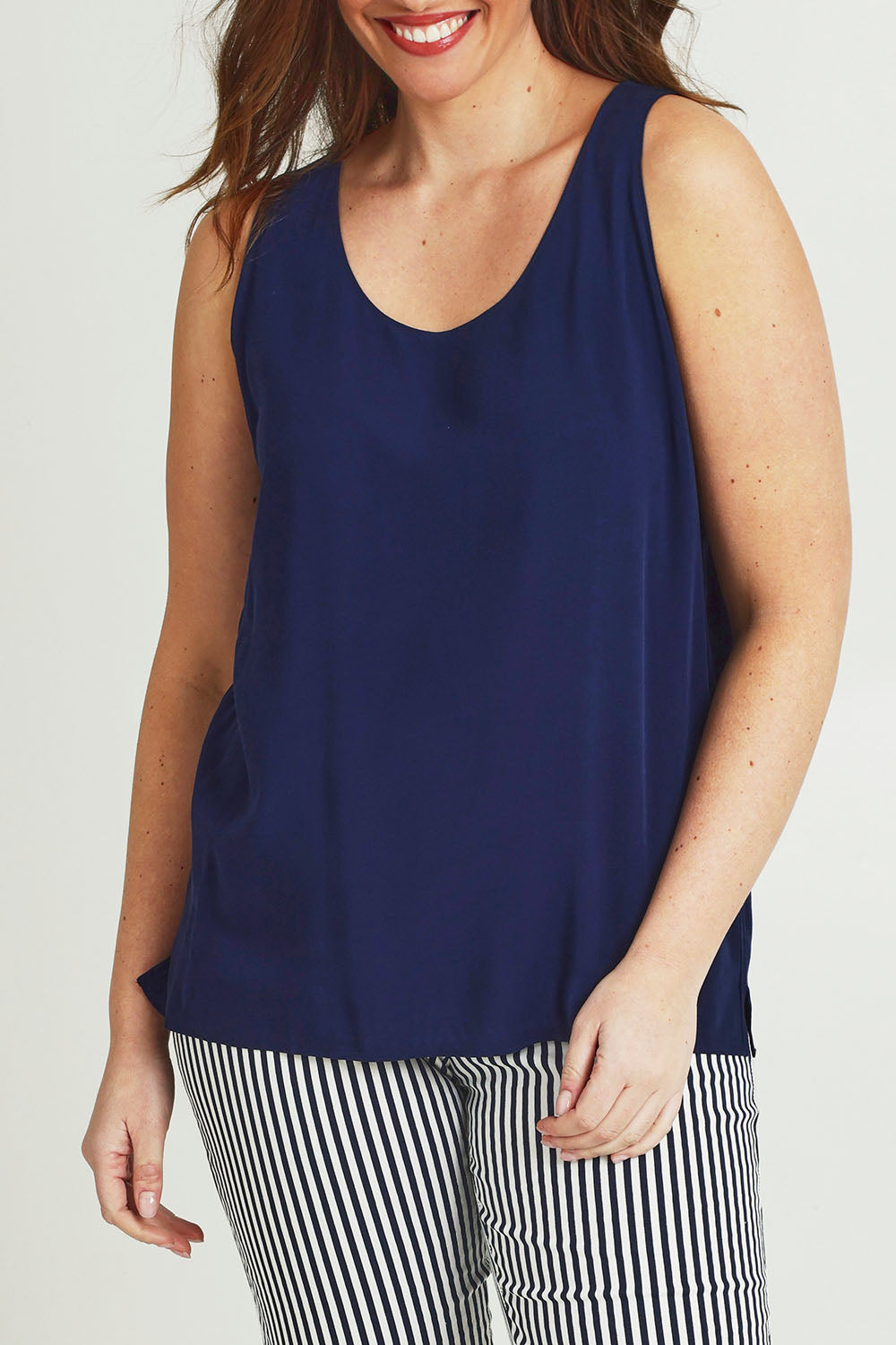 Model Jane wearing size 14 of The Keepers Essential Woven Tank in colour Navy (Blue), from the front, cropped image