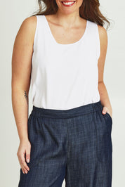 Model Jane wearing size 14 of The Keepers Essential Woven Tank in colour White (White), from the front, cropped image