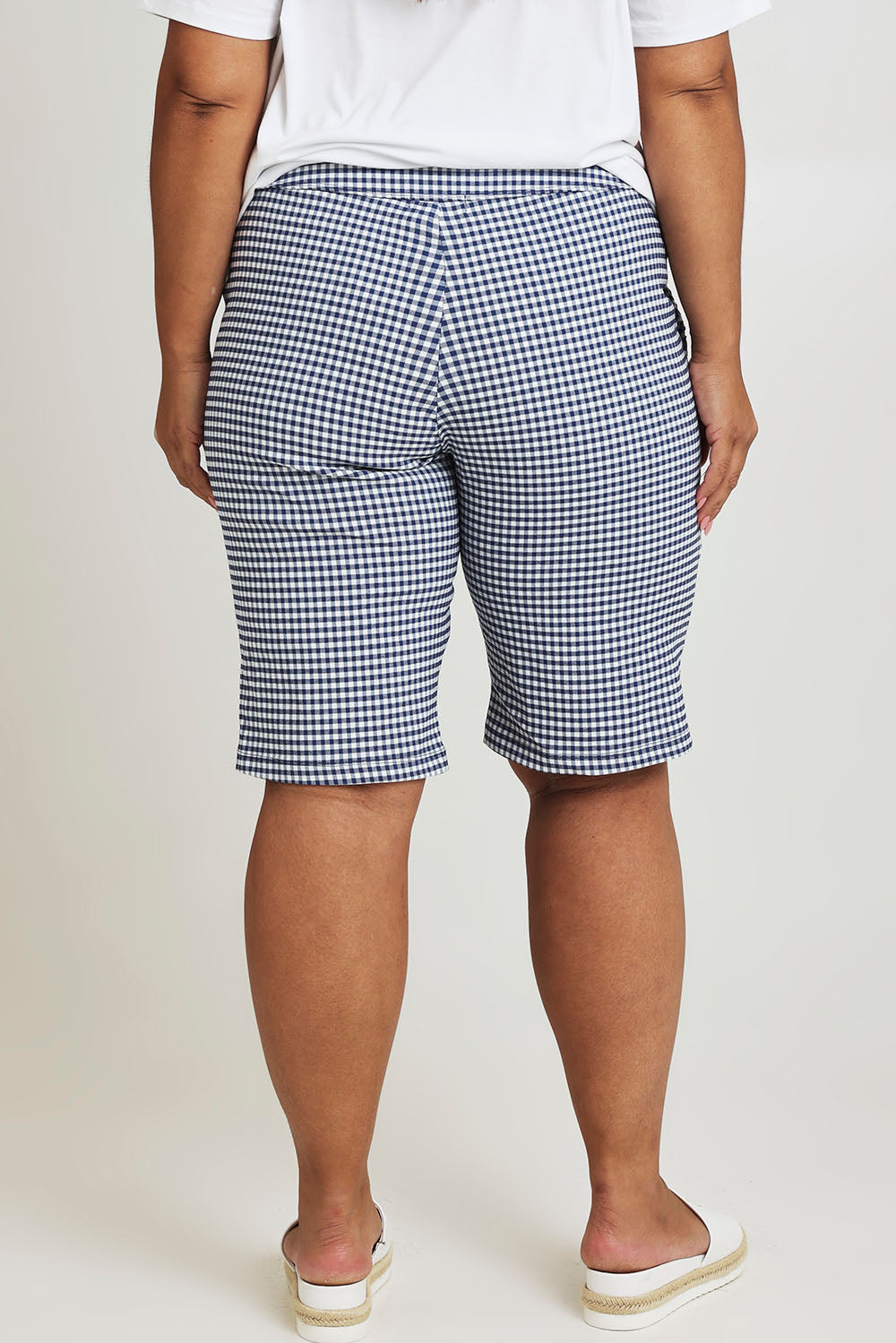 Model Ashleigh wearing size 16 of The Keepers Check Cotton Short in colour Navywhite (Blue), from the back