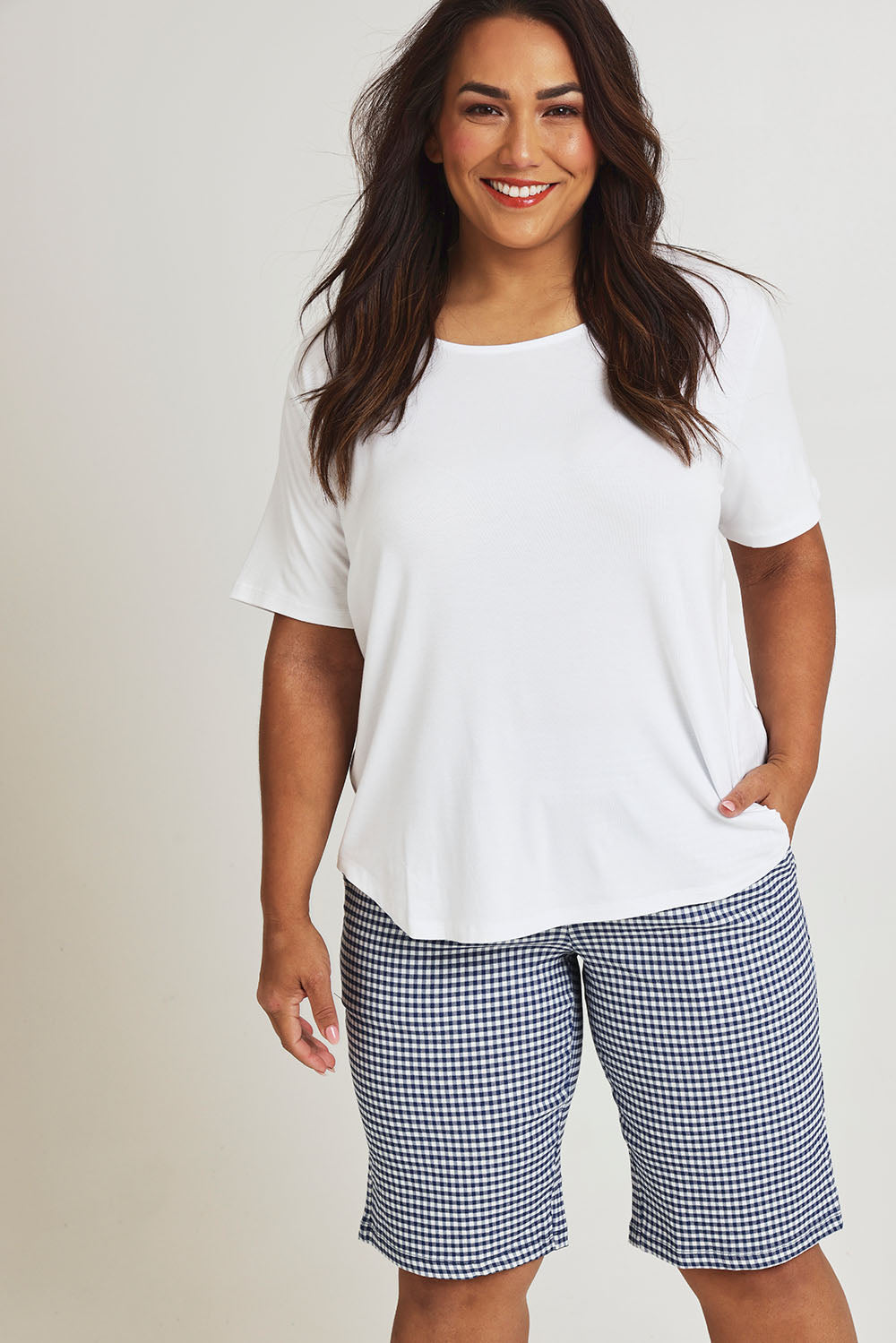 Model Ashleigh wearing size 16 of The Keepers Check Cotton Short in colour Navywhite (Blue), from the front, cropped image