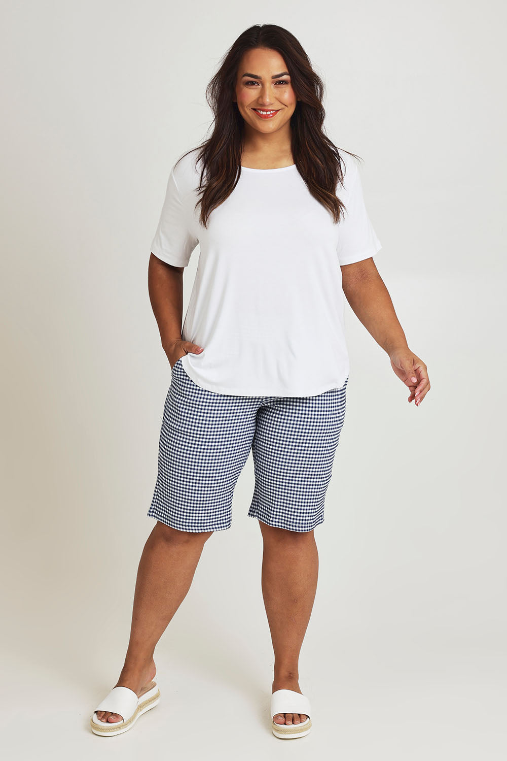 Model Ashleigh wearing size 16 of The Keepers Check Cotton Short in colour Navywhite (Blue), from the front, showing the whole outfit