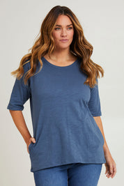 Model Laura wearing size 14 of The Cotton Slub Tunic in colour Denim (Blue), from the front, cropped image