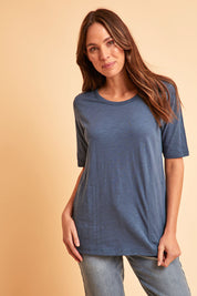 Model Madeline wearing size 10 of The Cotton Slub Tunic in colour Denim (Blue), from the front, showing the whole outfit