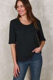 Model Madeline wearing size 10 of The Luxe Pima Cotton Tee in colour Black (Black), from the front, showing the whole outfit