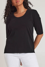 Model Terri-Leigh wearing size 14 of The Luxe Pima Cotton Tee in colour Black (Black), from the front, cropped image