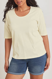 Model Terri-Leigh wearing size 14 of The Luxe Pima Cotton Tee in colour Lemon, from the front, cropped image