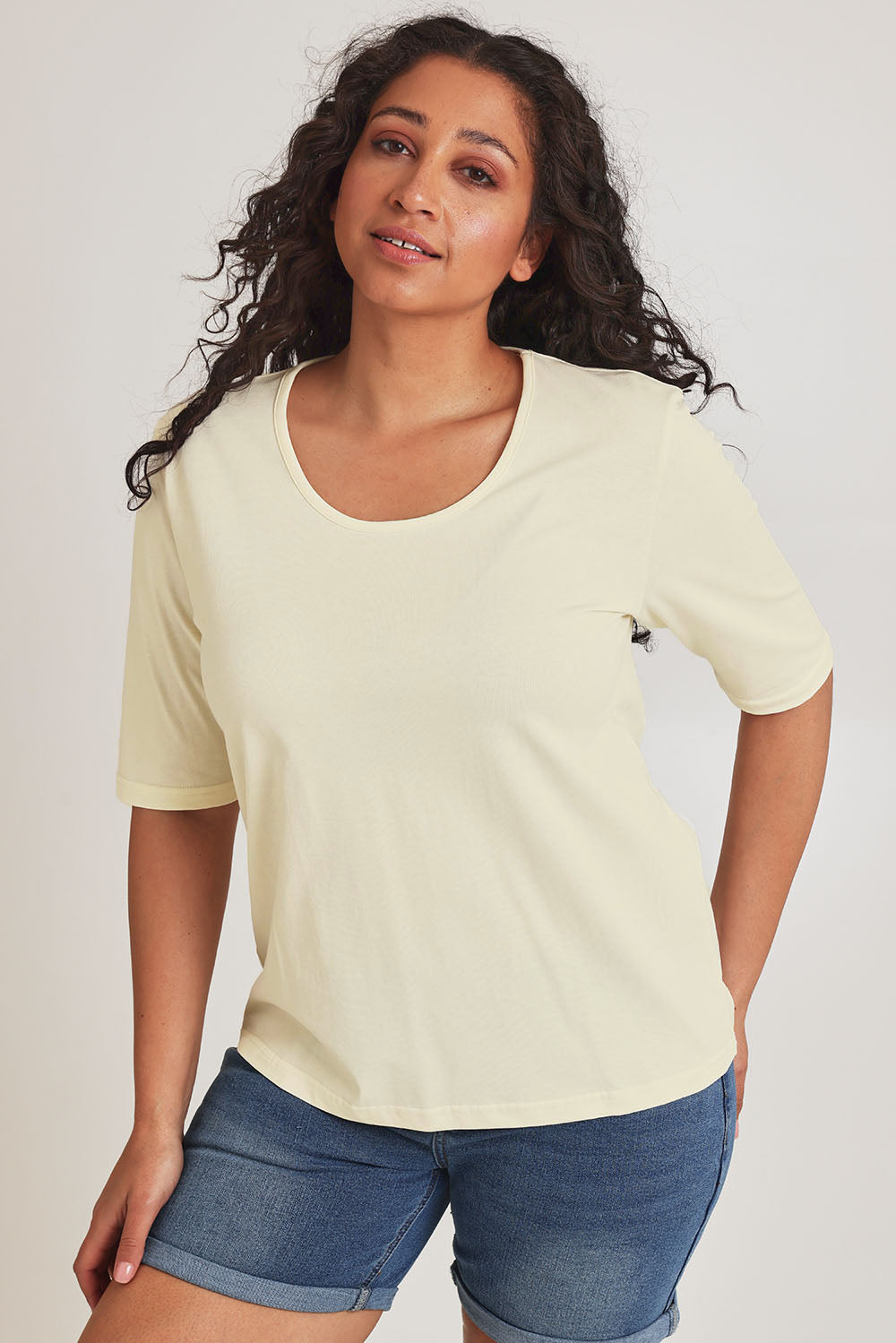 Model Terri-Leigh wearing size 14 of The Luxe Pima Cotton Tee in colour Lemon, from the front, cropped image