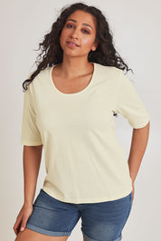 Model Terri-Leigh wearing size 14 of The Luxe Pima Cotton Tee in colour Lemon, from the front, cropped image