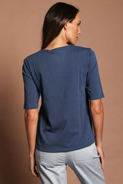 Model Madeline wearing size 10 of The Luxe Pima Cotton Tee in colour Opal (Blue), from the back