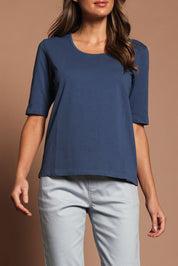 Model Madeline wearing size 10 of The Luxe Pima Cotton Tee in colour Opal (Blue), from the front, cropped image