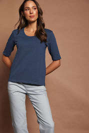 Model Madeline wearing size 10 of The Luxe Pima Cotton Tee in colour Opal (Blue), from the front, showing the whole outfit