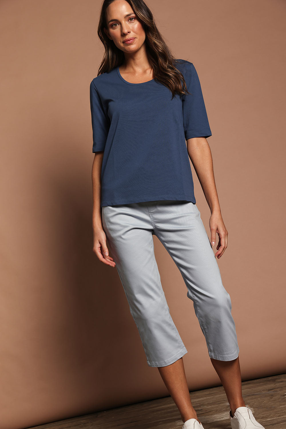 Model Madeline wearing size 10 of The Luxe Pima Cotton Tee in colour Opal (Blue), from the front, showing the whole outfit