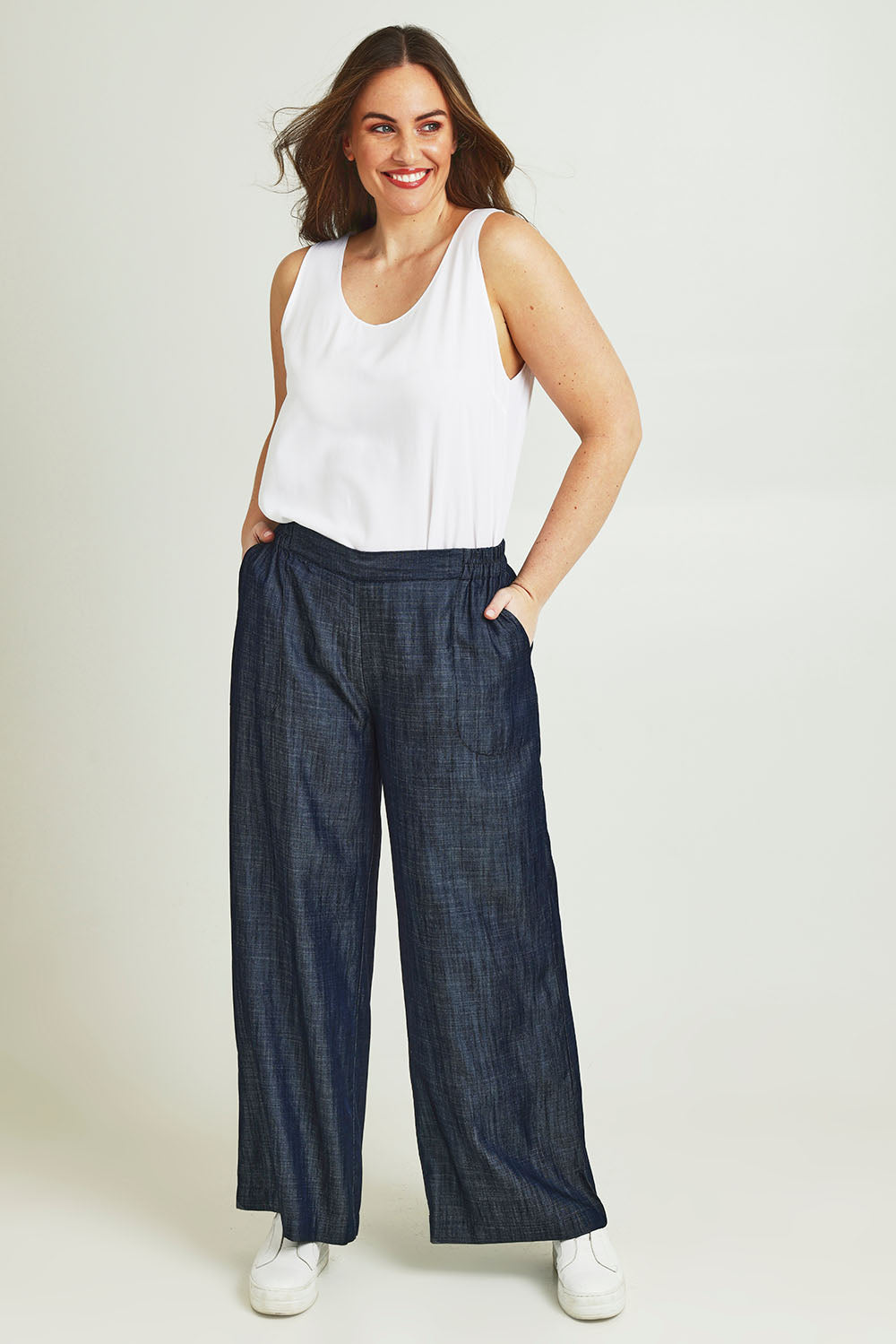 Model Jane wearing size 14 of The Luxe Chambray Pull On Pant in colour Darkdenim (Blue), from the front, showing the whole outfit