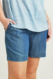 Model Jane wearing size 14 of The Shirred Waist Pull On Shorts in colour Denimblue (Blue), from the front, cropped image