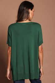 Model Madeline wearing size S of The All Season V Neck High Low Tee in colour Cactus (Green), from the back