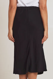 Model Terri-Leigh wearing size 14 of The Pull On Bias Skirt in colour Black (Black), from the back