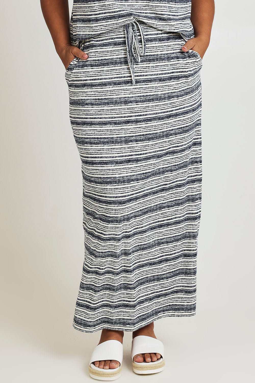 Model Ashleigh wearing size 16 of The Striped Pull On Skirt in colour Navystripe (Blue), from the front, cropped image