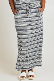 Model Ashleigh wearing size 16 of The Striped Pull On Skirt in colour Navystripe (Blue), from the front, cropped image