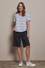 Model Madeline wearing size 10 of The Rib Waistband Short in colour Black (Black), from the front, showing the whole outfit