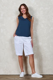 Model Madeline wearing size 10 of The Rib Waistband Short in colour White (White), from the front, showing the whole outfit