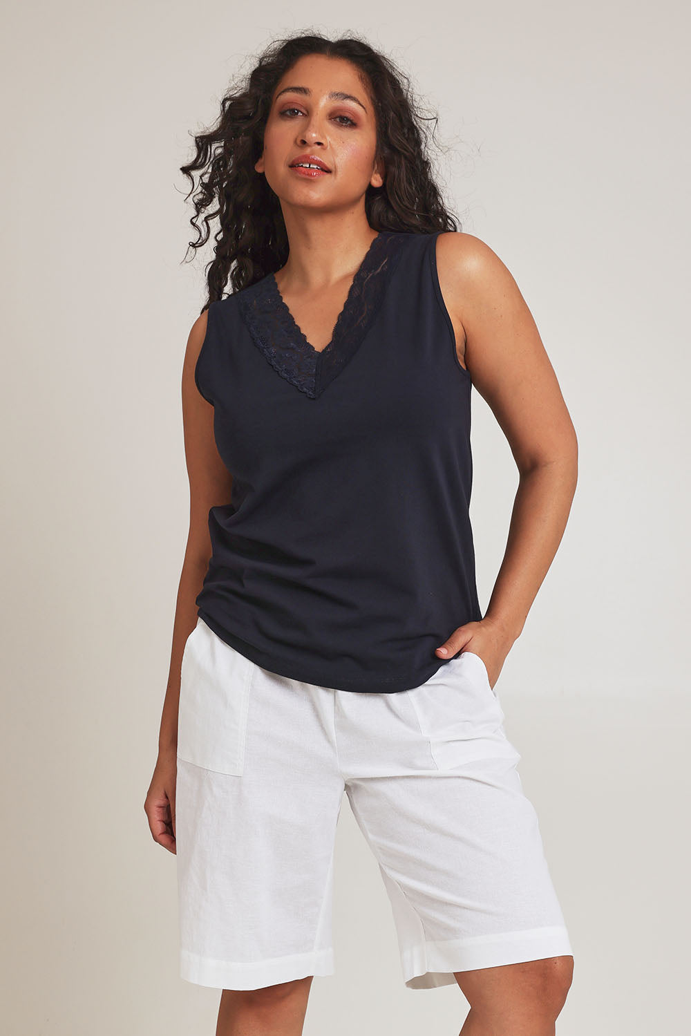 Model Terri-Leigh wearing size 14 of The Rib Waistband Short in colour White (White), from the front, cropped image