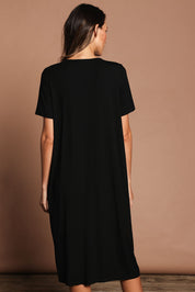 Model Madeline wearing size 10 of The Pack & Go Luxe Bamboo Button Up Dress with Pockets in colour Black (Black), from the back