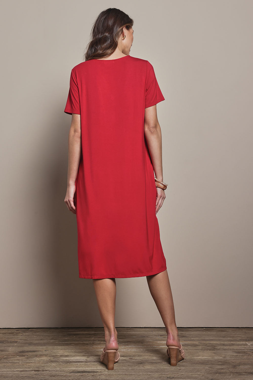 Model Madeline wearing size 10 of The Pack & Go Luxe Bamboo Button Up Dress with Pockets in colour Cherryred (Red), from the back