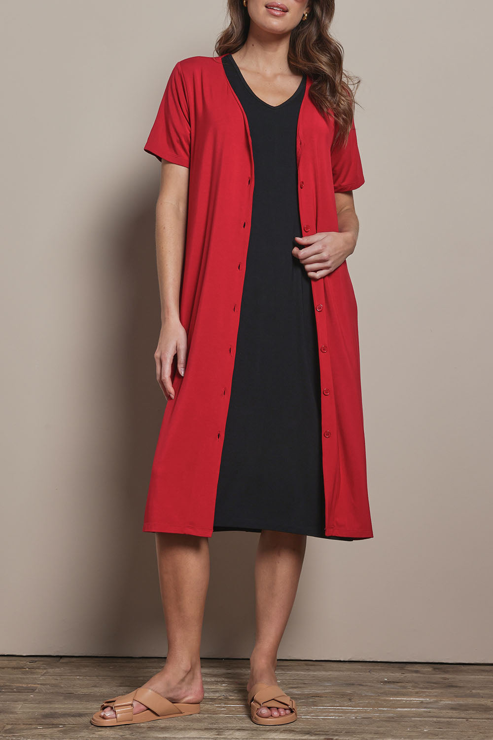 Model Madeline wearing size 10 of The Pack & Go Luxe Bamboo Button Up Dress with Pockets in colour Cherryred (Red), from the front, cropped image