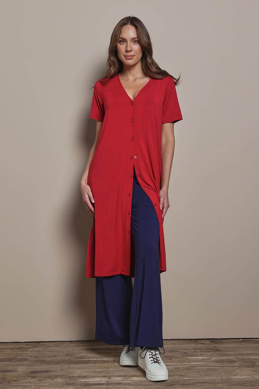Model Madeline wearing size 10 of The Pack & Go Luxe Bamboo Button Up Dress with Pockets in colour Cherryred (Red), from the front, showing the whole outfit
