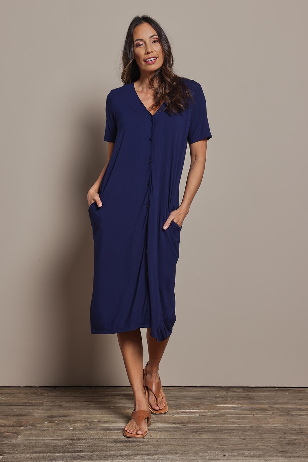 Model Amanda wearing size 10 of The Pack & Go Luxe Bamboo Button Up Dress with Pockets in colour Frenchnavy (Blue), from the front, showing the whole outfit