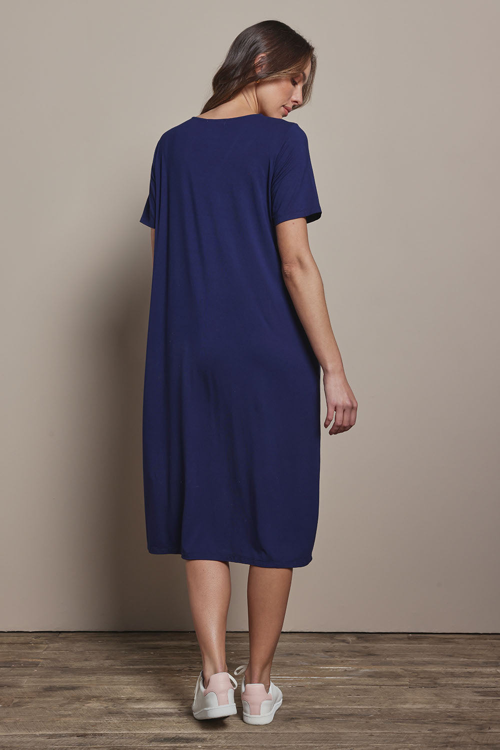 Model Madeline wearing size 10 of The Pack & Go Luxe Bamboo Button Up Dress with Pockets in colour Frenchnavy (Blue), from the back