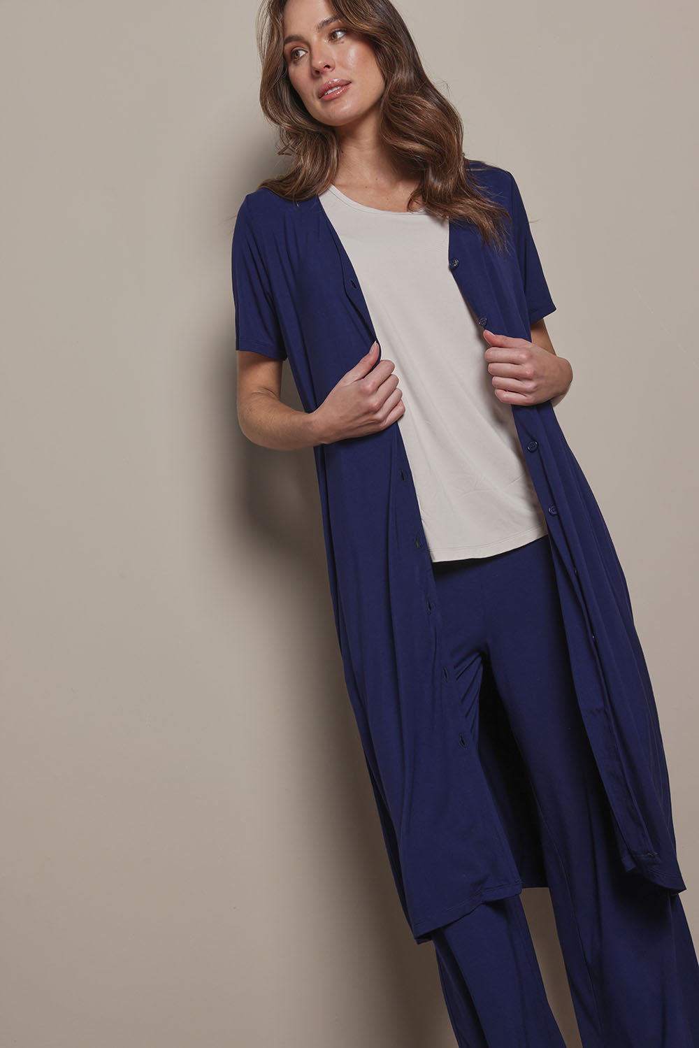 Model Madeline wearing size 10 of The Pack & Go Luxe Bamboo Button Up Dress with Pockets in colour Frenchnavy (Blue), from the front, cropped image