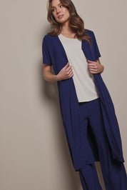 Model Madeline wearing size 10 of The Pack & Go Luxe Bamboo Button Up Dress with Pockets in colour Frenchnavy (Blue), from the front, cropped image