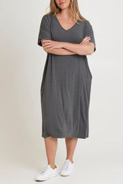 Model Chanel wearing size 16 of The Pack & Go Luxe Bamboo Pull On Dress with Pockets in colour Charcoal (Grey), from the front, cropped image