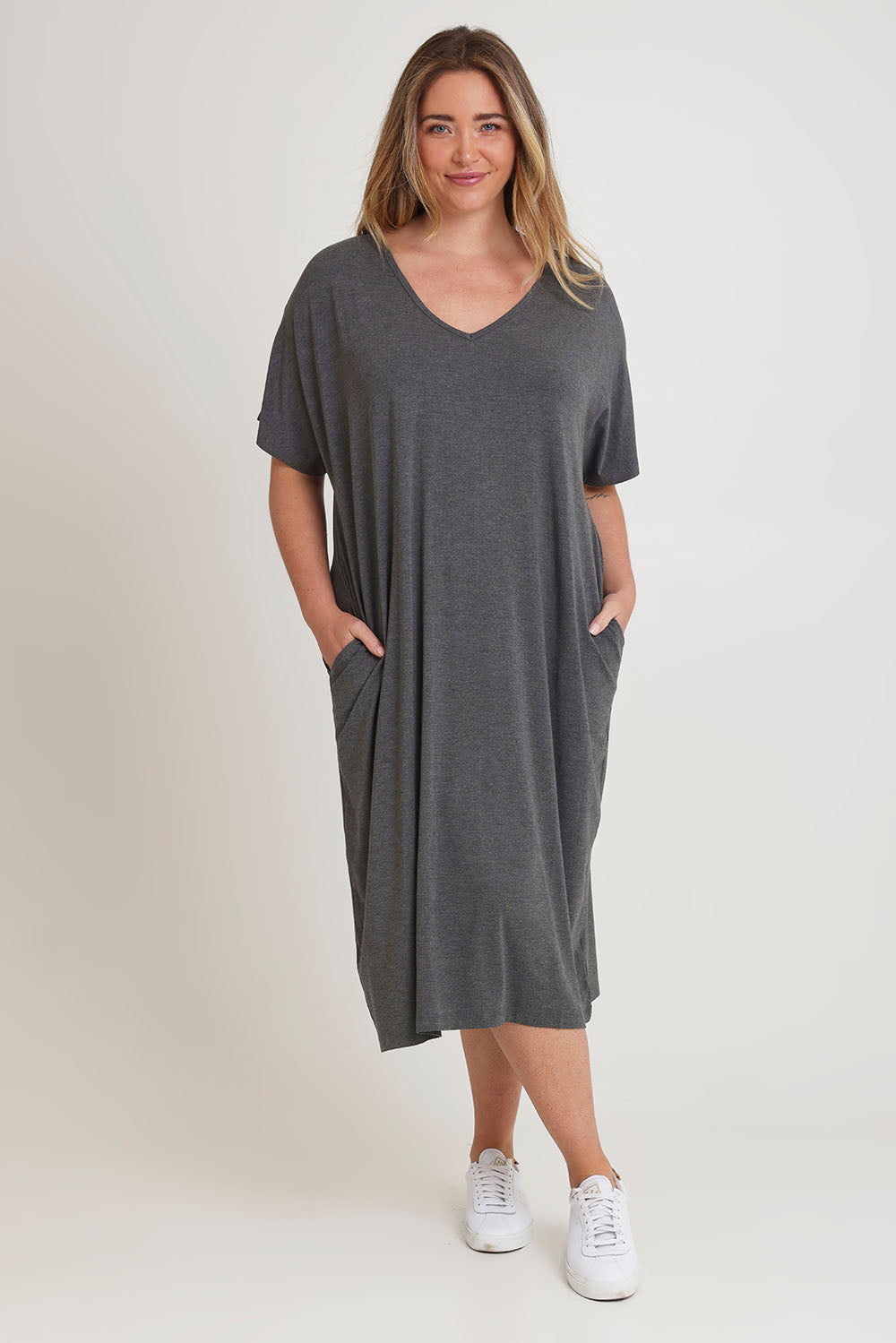 Model Chanel wearing size 16 of The Pack & Go Luxe Bamboo Pull On Dress with Pockets in colour Charcoal (Grey), from the front, showing the whole outfit