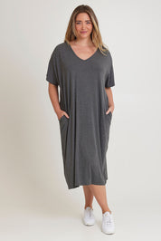 Model Chanel wearing size 16 of The Pack & Go Luxe Bamboo Pull On Dress with Pockets in colour Charcoal (Grey), from the front, showing the whole outfit
