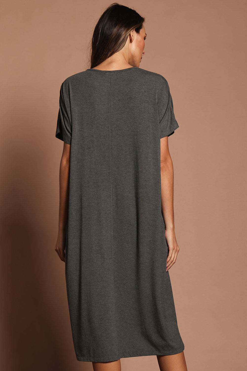 Model Madeline wearing size 10 of The Pack & Go Luxe Bamboo Pull On Dress with Pockets in colour Charcoal (Grey), from the back