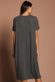 Model Madeline wearing size 10 of The Pack & Go Luxe Bamboo Pull On Dress with Pockets in colour Charcoal (Grey), from the back
