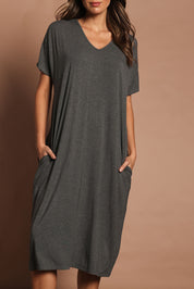 Model Madeline wearing size 10 of The Pack & Go Luxe Bamboo Pull On Dress with Pockets in colour Charcoal (Grey), from the front, cropped image