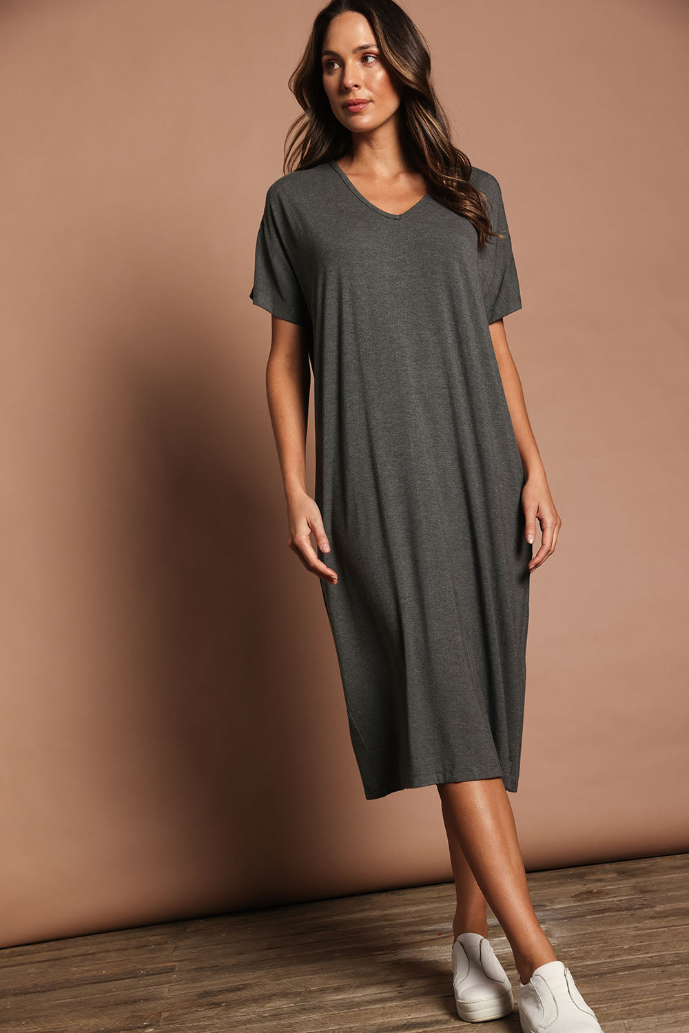 Model Madeline wearing size 10 of The Pack & Go Luxe Bamboo Pull On Dress with Pockets in colour Charcoal (Grey), from the front, showing the whole outfit