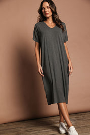 Model Madeline wearing size 10 of The Pack & Go Luxe Bamboo Pull On Dress with Pockets in colour Charcoal (Grey), from the front, showing the whole outfit