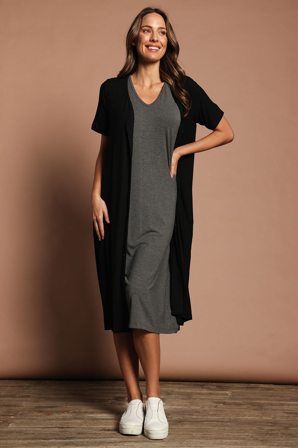 Model Madeline wearing size 10 of The Pack & Go Luxe Bamboo Pull On Dress with Pockets in colour Charcoal (Grey), from the front, showing the whole outfit