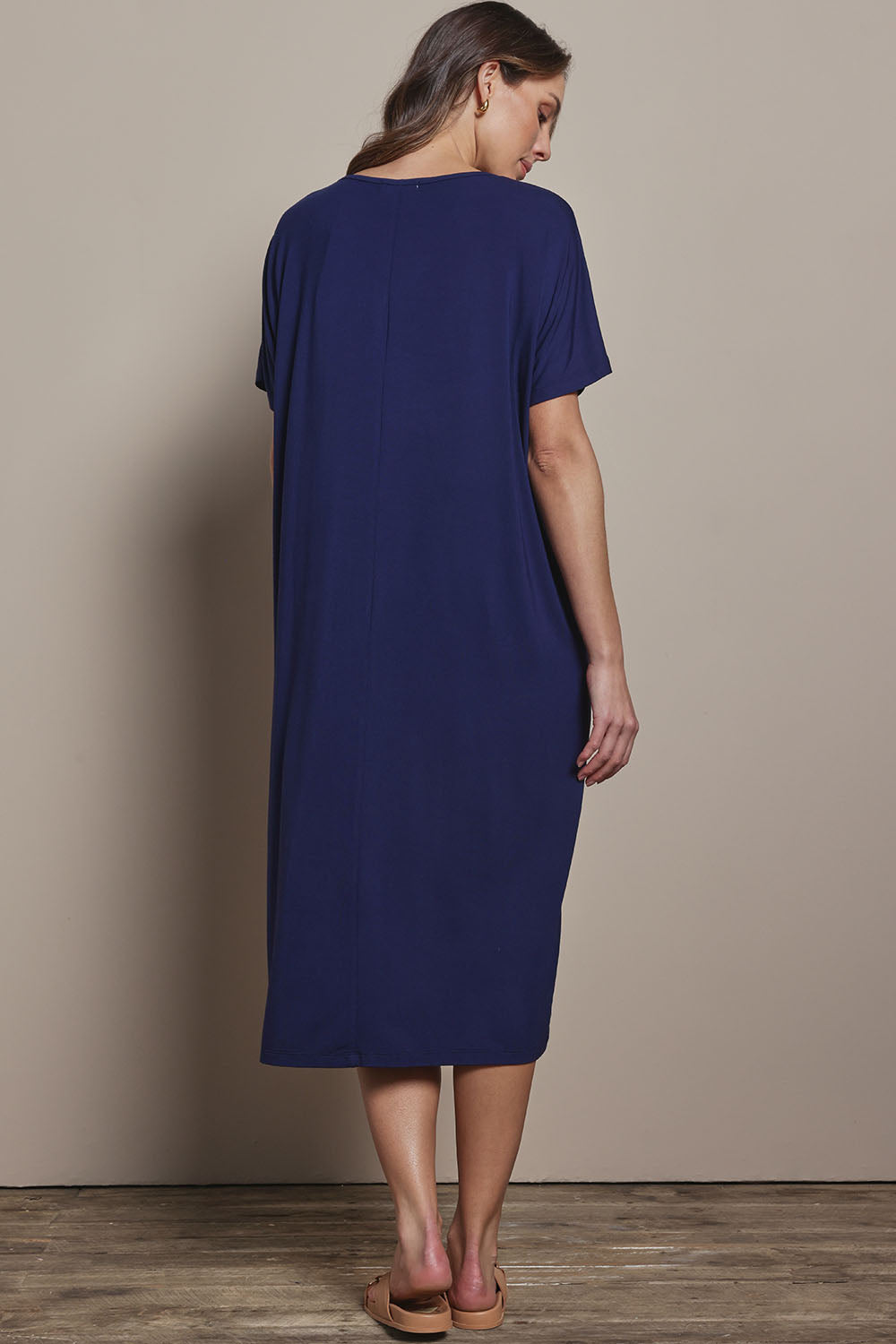 Model Madeline wearing size 10 of The Pack & Go Luxe Bamboo Pull On Dress with Pockets in colour Frenchnavy (Blue), from the back